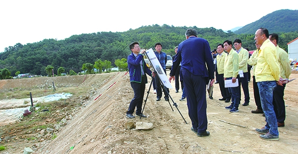 ▶ 지난 23일 ‘생활쓰레기 매립장 토사제방 설지공사’ 현지 확인 중인 의원들의 모습